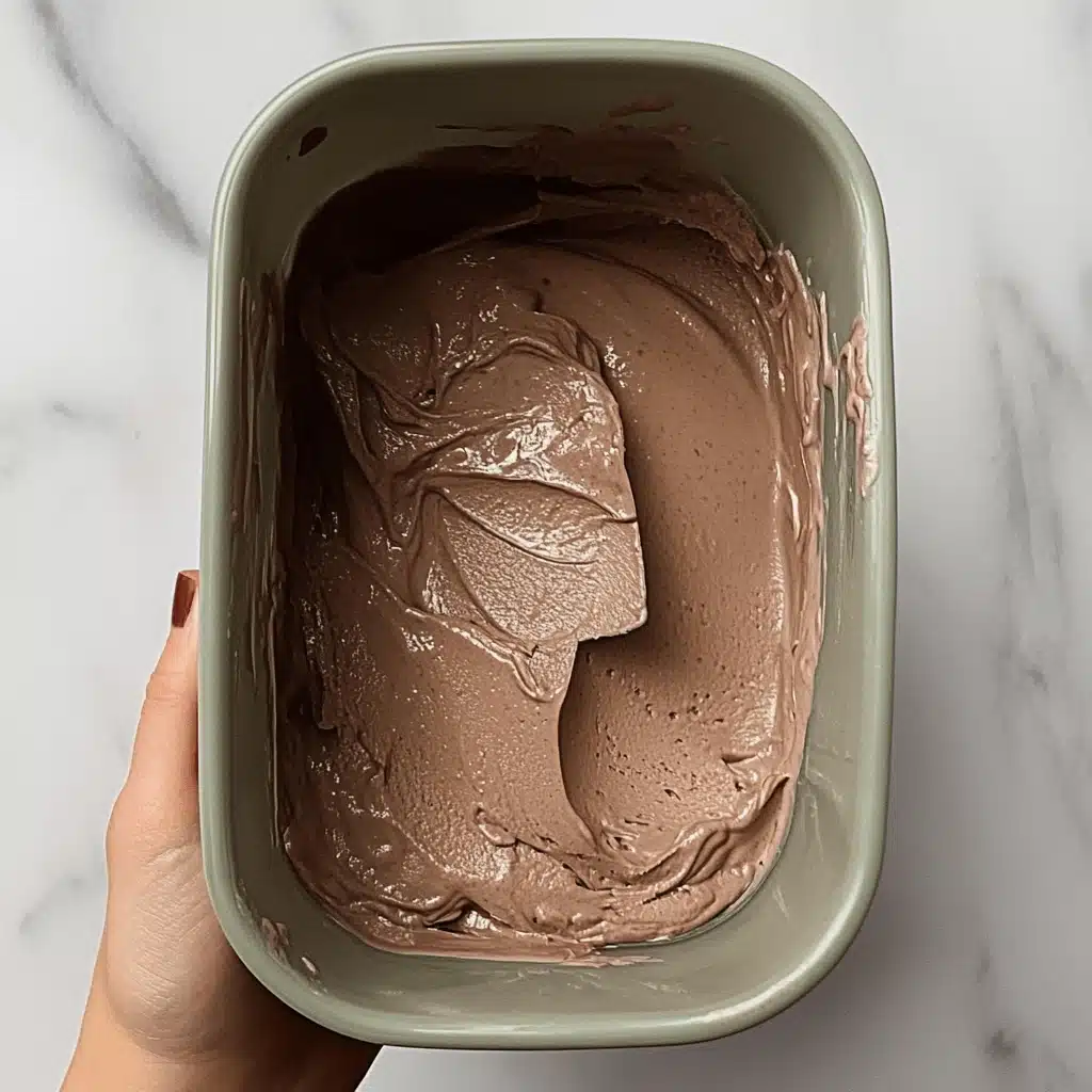 Best High-Protein Chocolate Cottage Cheese Ice Cream – Guilt-Free & Easy! 10 pouring the cottage cheese chocolate ice cream mixture into the container