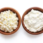 Cottage Cheese vs Greek Yogurt in Protein Bagels: 1 Clear Winner 6 Cottage cheese vs Greek yogurt texture, chunky vs smooth in wooden bowls