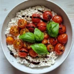 The Ultimate Guide to Cottage Cheese Meal Prep for Dinner 110 A white bowl filled with whole milk cottage cheese is set on a wooden countertop in soft natural lighting, topped with burst cherry tomatoes, fresh basil, balsamic glaze, and cracked black pepper.