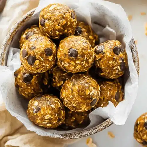 Homemade Pumpkin Protein Balls with oats and chocolate chips in a rustic bowl, ready to enjoy as a healthy snack.