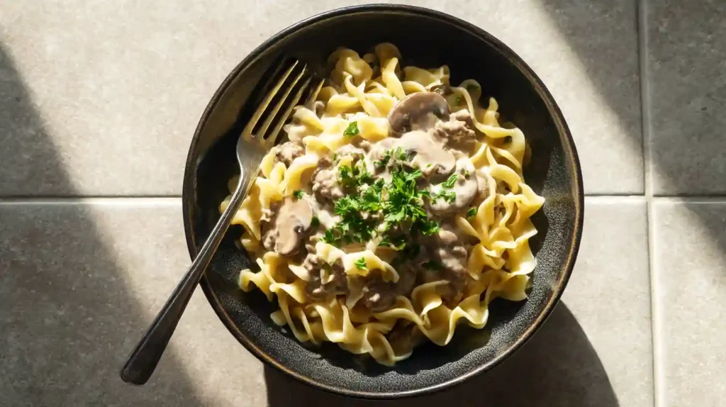 High-Protein Beef Stroganoff: A Healthier Twist on a Classic 2 High-protein beef stroganoff served over egg noodles, topped with creamy mushroom sauce and fresh parsley.