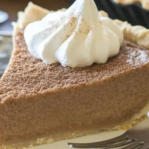 The Best Creamy Cinnamon Pie Recipe 4 Slice of creamy cinnamon pie with a smooth cinnamon filling and whipped cream on top.