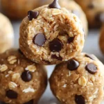 Peanut butter protein balls made with oats and chocolate chips stacked on a tray