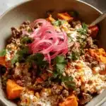 Vibrant Street corn beef and sweet potato bowls with pickled red onions, creamy corn, and fresh cilantro.