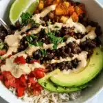 Vibrant Black Bean and Rice Bowl with avocado, roasted vegetables, and fresh cilantro.